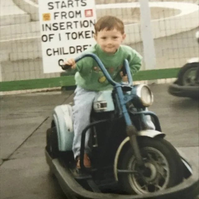 Blair as a toddler on a ride-on motorbike